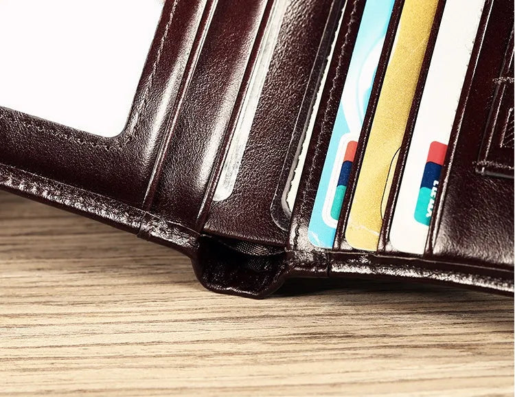 Men's brown leather bifold wallet open to show card slots, coin pocket, and banknote compartment.