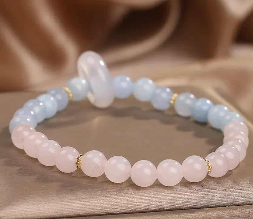 Natural aquamarine crystal beaded bracelet with pink electroplated finish on display