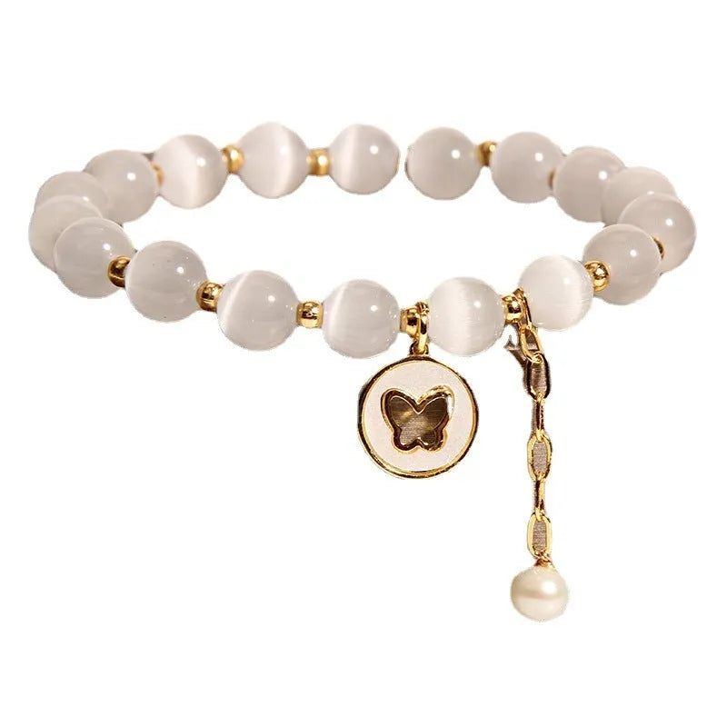 White Korean-style geometric bracelet with a cat's eye crystal on a stretch elastic band.