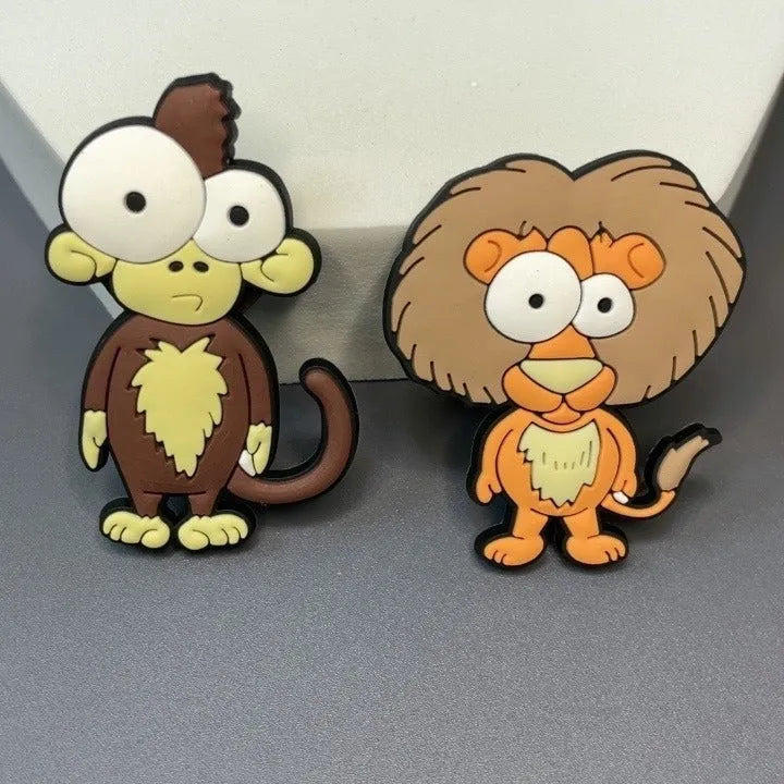 Set of 9 PVC cartoon animal refrigerator stickers with safari animals including monkey, lion, and giraffe on a white fridge door.