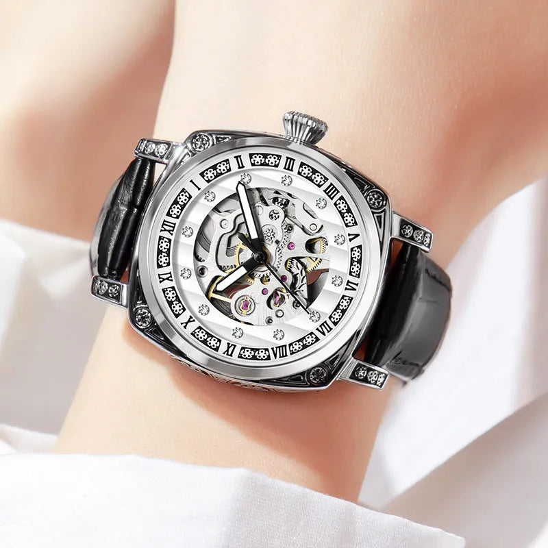 Mechanical watch with luminous hands on a leather strap, shown in black, red, steel, and white colour variants.