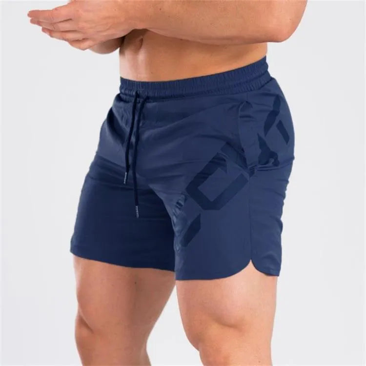 Men's black quick-drying nylon blend training shorts with elastic waist, shown in knee-length sports style.