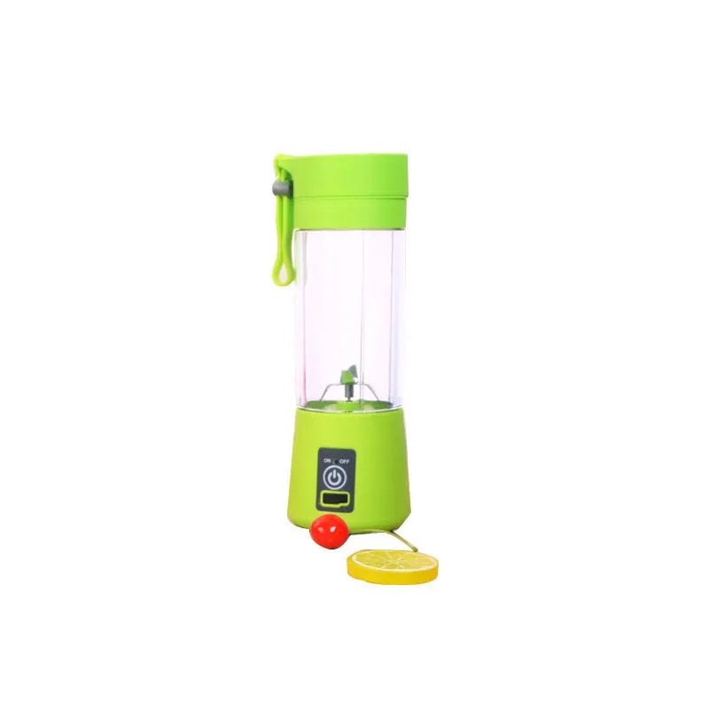 Pink mini USB electric centrifugal fruit juicer with stainless steel blade on a table.