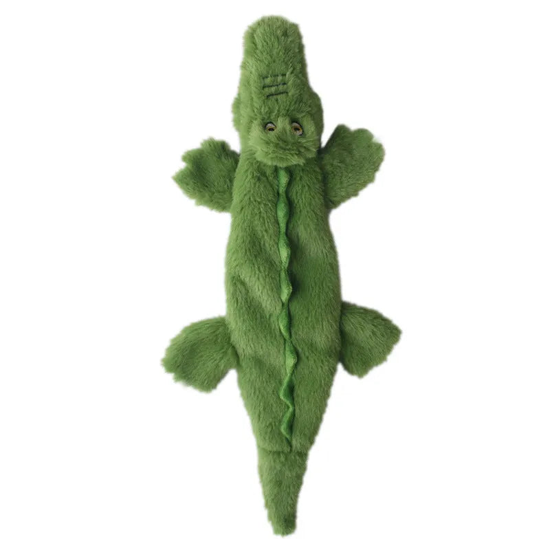 Green plush crocodile dog toy with no stuffing, featuring a squeaker and crinkle paper tail.