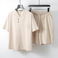 A loose-fit men's two-piece clothing set showing a short-sleeve top and matching shorts in a cotton fabric.