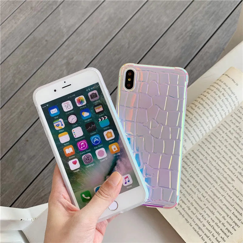Silver glossy laser design silicone case for iPhone on a table.