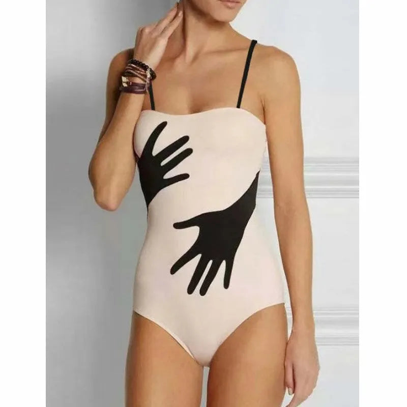Women's patterned one-piece bikini with a matching lightweight tulle skirt.