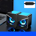 Compact black or white USB mini speaker for computer desktop use with wired connection.