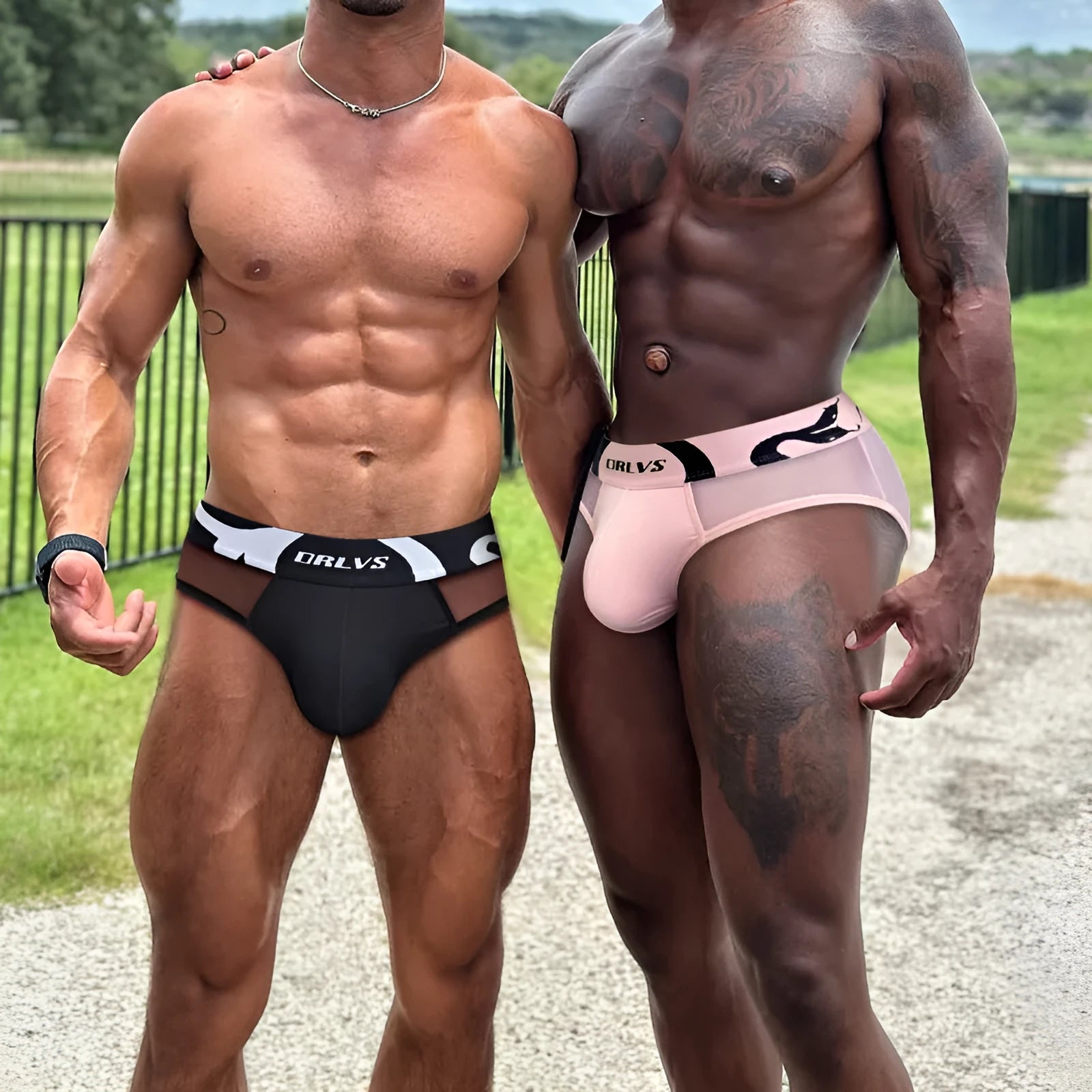 Men's solid colour cotton boxer shorts on a low waist, shown in black, pink, and red.