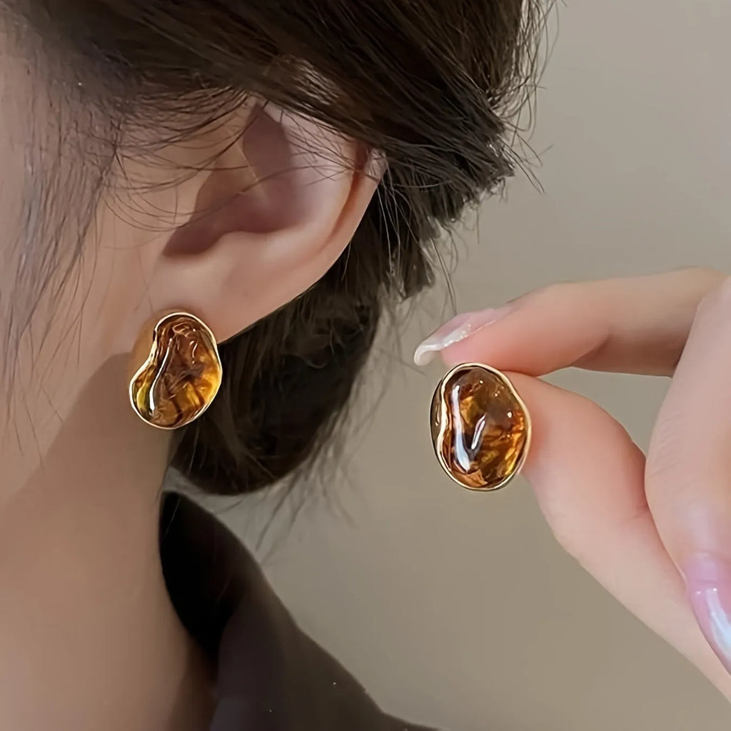 Three pairs of handmade geometric earrings with electroplated alloy construction and tassel detailing