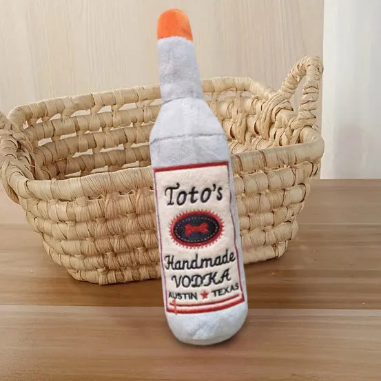 Brown plush wine bottle shaped dog toy with squeaky feature for interactive chew play