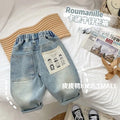 Light-coloured boys denim jeans with printed back pocket and elastic waist, front view