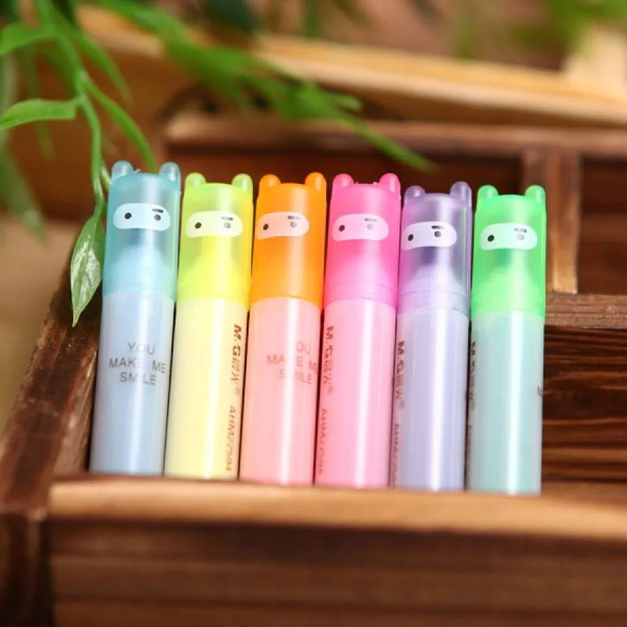 Set of six plastic highlighter pens with oblique tips in different colours for text marking