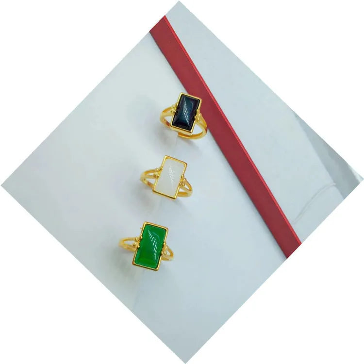 Gold-plated brass ring with a long green gemstone on an adjustable band.