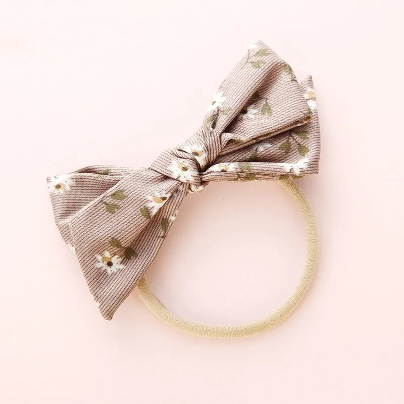Children's cloth hair band with knotted bow design showing Snow White princess pattern
