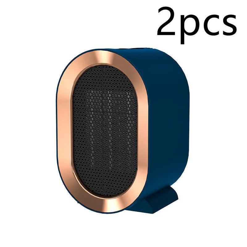 Compact black desktop electric fan heater with a front grille and mechanical control dial.