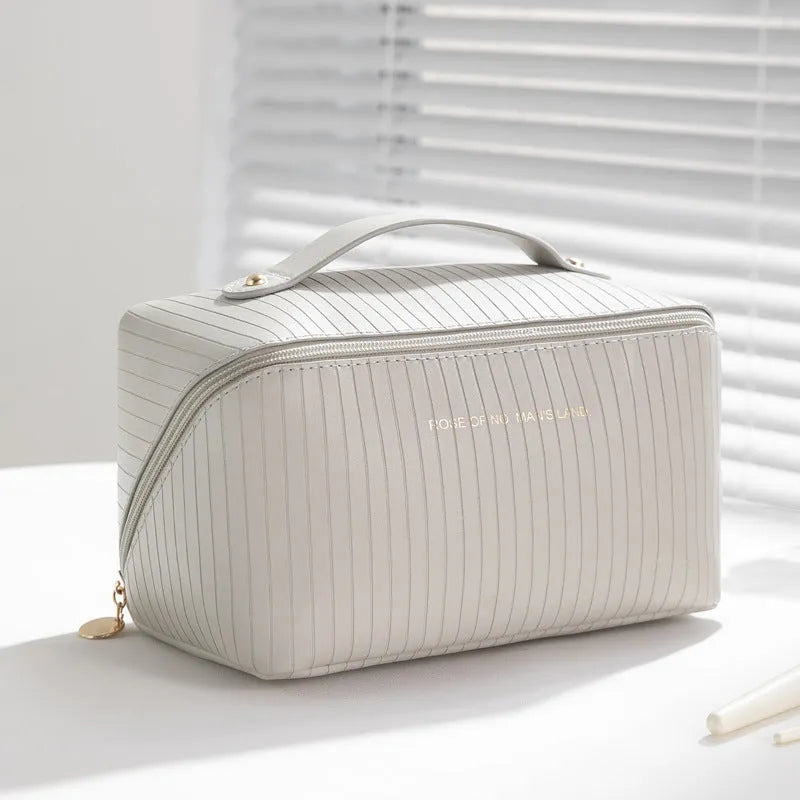 Vertical stripe pattern cubic makeup bag in PU material measuring 22.5cm wide
