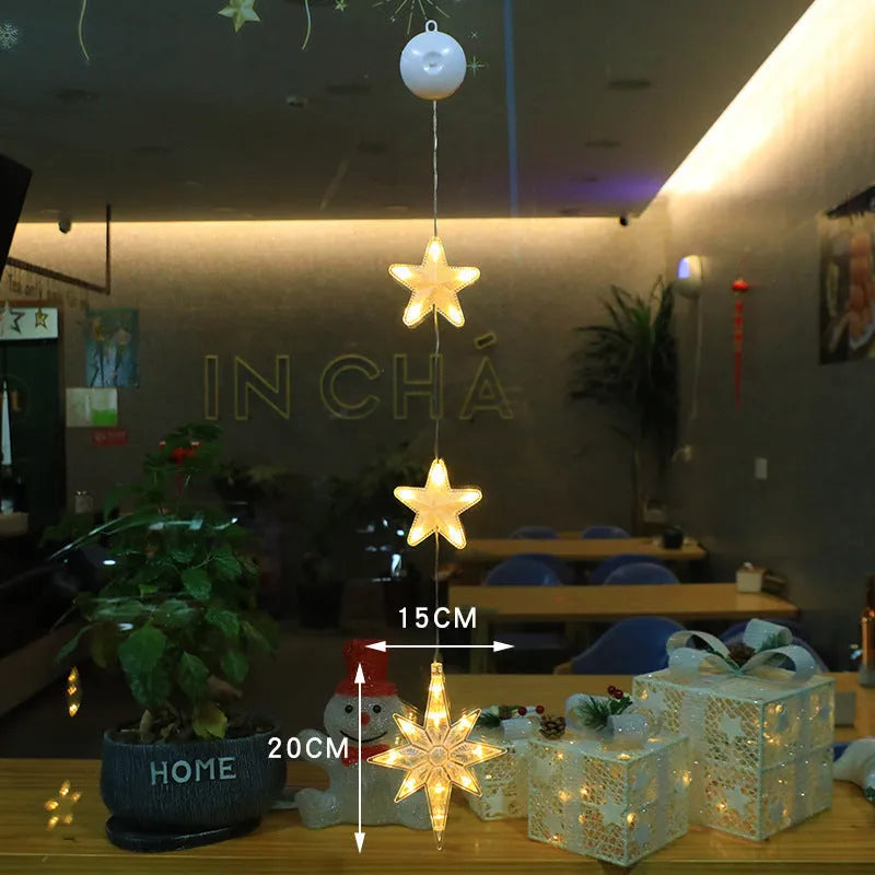 Set of three battery-powered LED Christmas pendant lights with suction cups, showing star, tree, and deer designs.