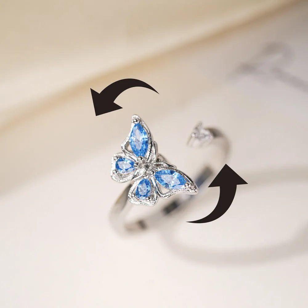 Butterfly adjustable ring with electroplated white gold finish and blue diamond accent on copper base