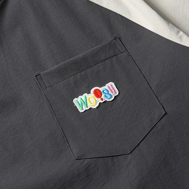 Dark grey men's quick-dry T-shirt with contrast colour raglan sleeves on a hanger.