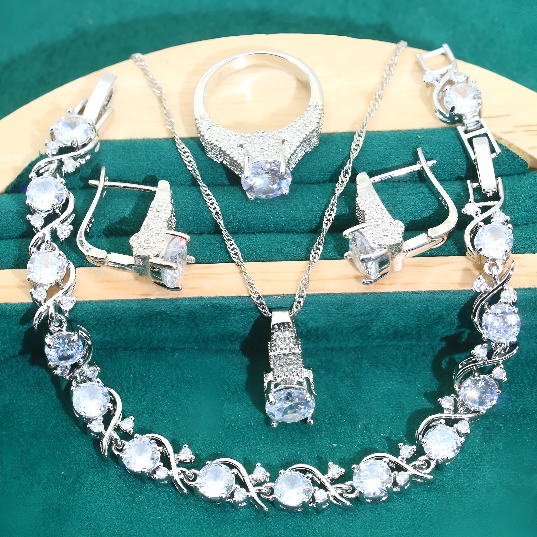 Bridal four-piece jewellery set showing necklace, earrings, ring and bracelet with water wave chain design