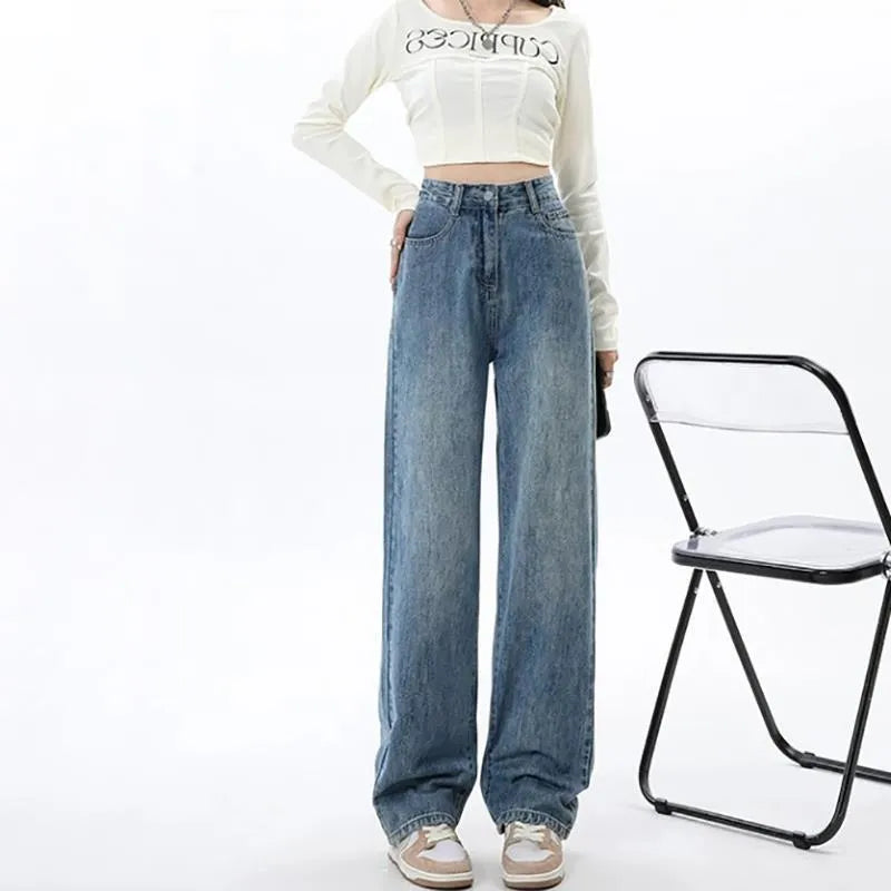 Woman wearing retro blue high-waisted wide-leg jeans with a straight-leg cut.