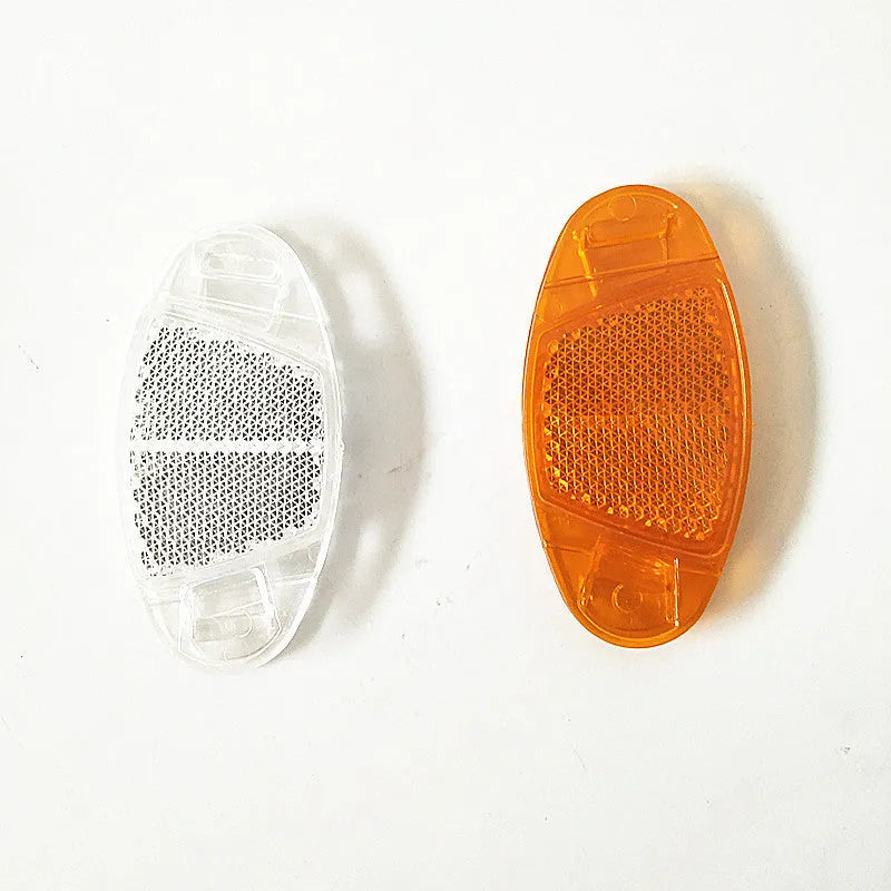 Bicycle spoke reflector decoration in white or yellow measuring 7.2cm by 3.5cm