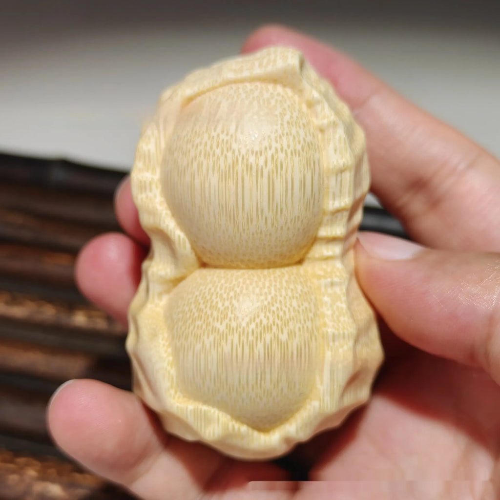 Modern simplicity style solid bamboo carving peanut ornament on a neutral background.