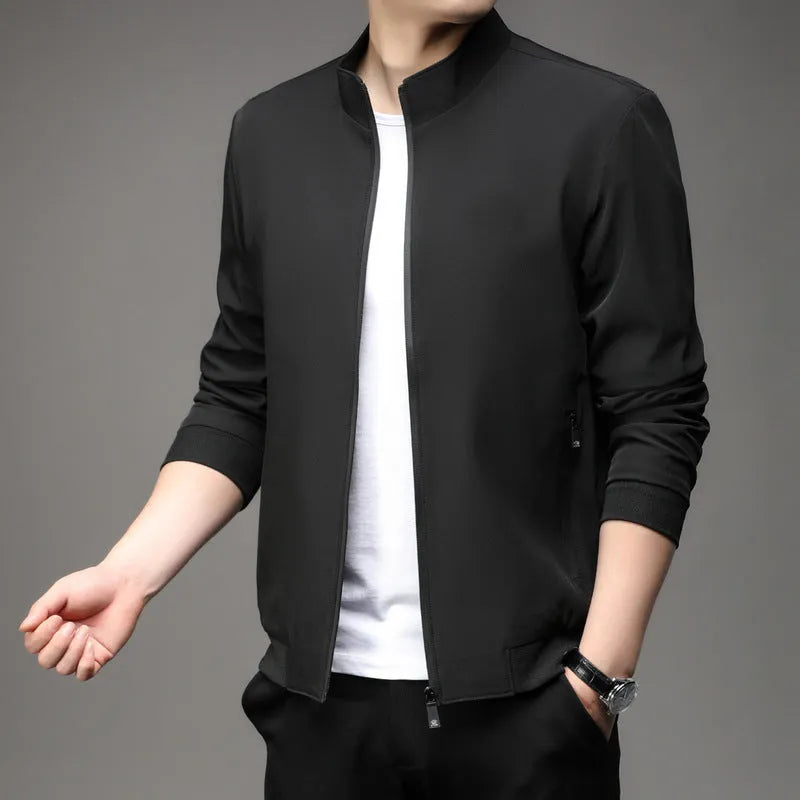 Man wearing a loose-fit grey Korean-style lapel casual jacket with zipper pockets.