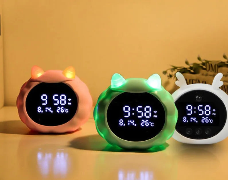 White Deer style smart alarm clock with luminous silicone dial on a bedside table