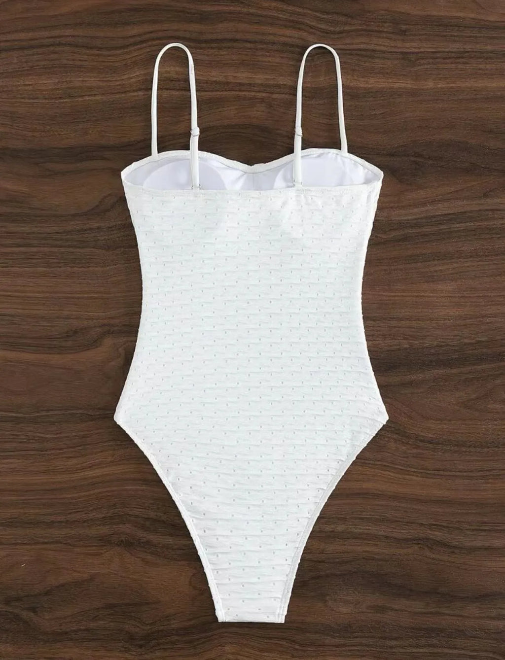 White one-piece sling-back swimsuit for women on a mannequin, showing briefs style.