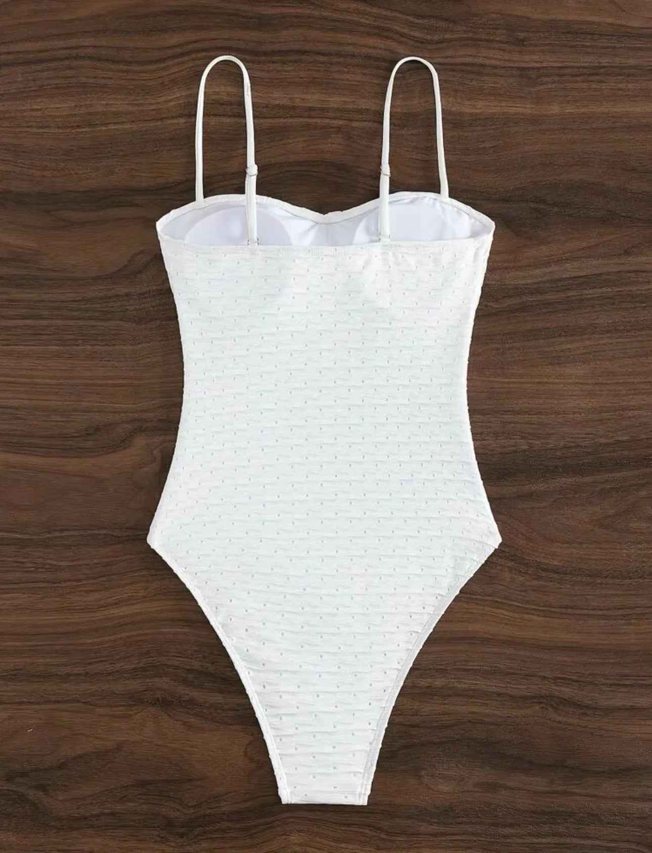White one-piece sling-back swimsuit for women on a mannequin, showing briefs style.