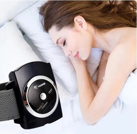 Black ABS anti snore wristband with biosensor and infrared therapy displayed on a flat surface