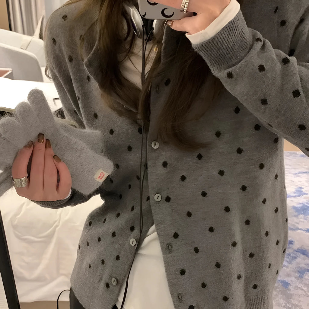 Women's grey and black Korean-style loose knit cardigan with crochet flower detail on the front.
