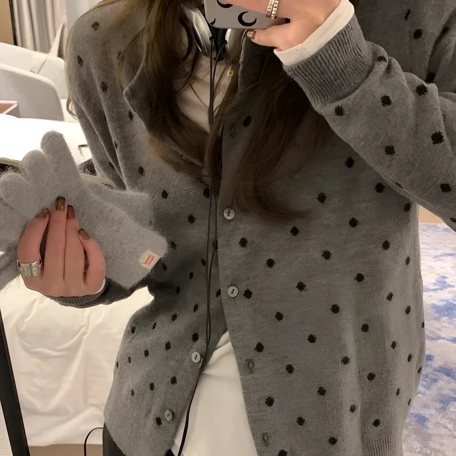 Women's grey and black Korean-style loose knit cardigan with crochet flower detail on the front.