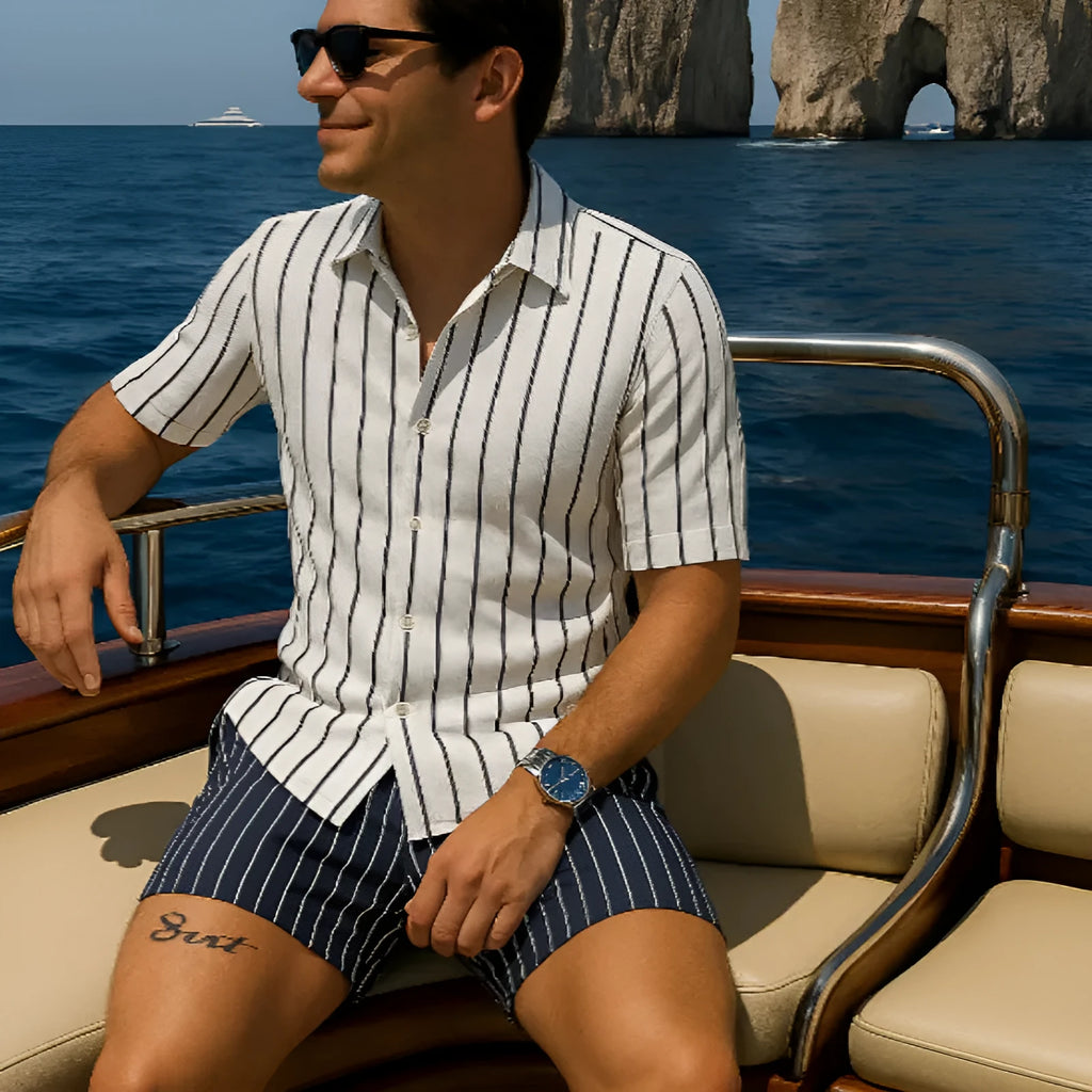 Men's light blue beach shirt and shorts set on a hanger, showing casual styling.
