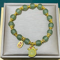 Simple women's bracelet with a peace buckle charm, coloured glass beads, and a small rabbit charm.