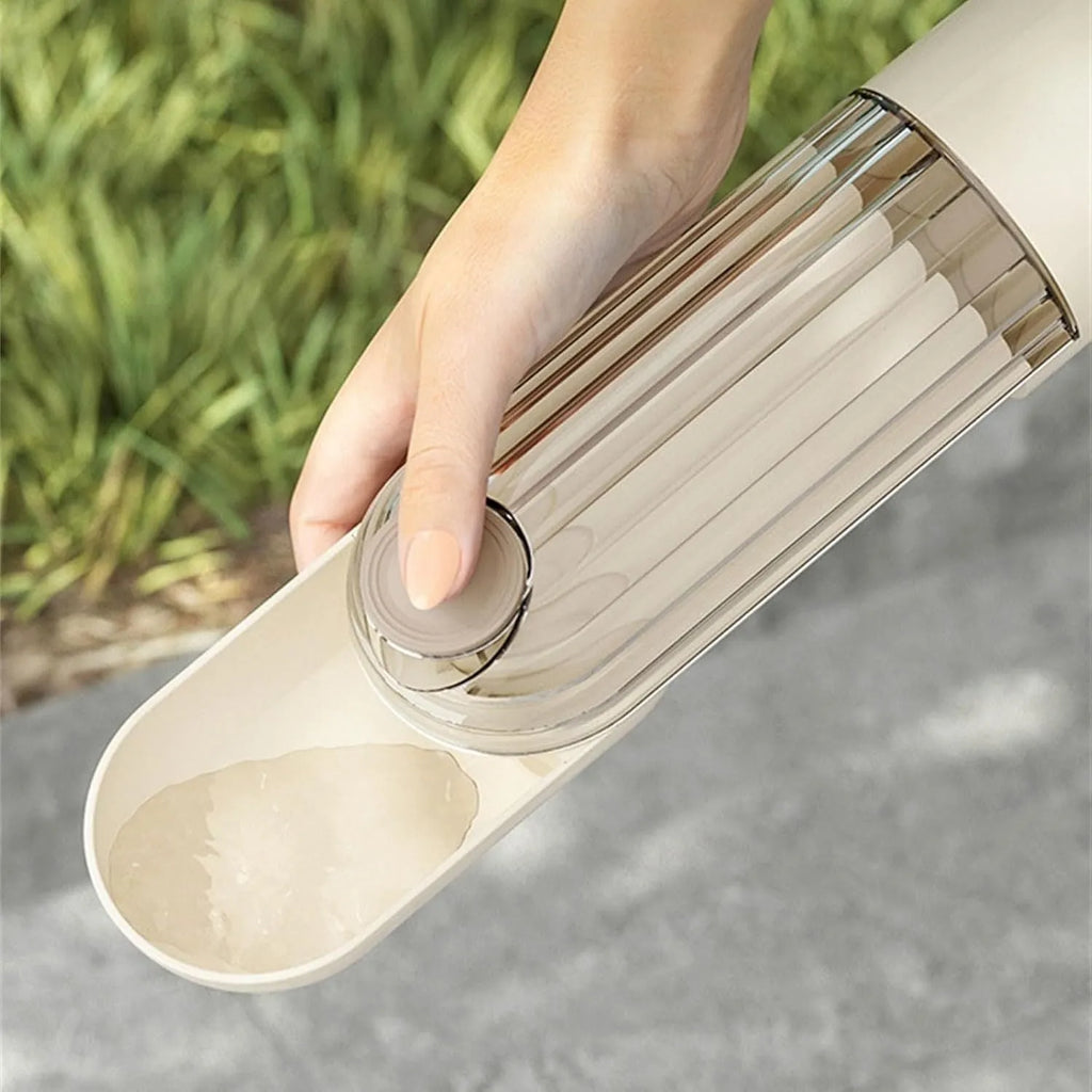 Foldable dog water bottle with food dispenser in beige or green colour for walking and hiking