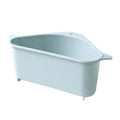 Beige and blue plastic triangle sink storage rack with suction cups holding a sponge