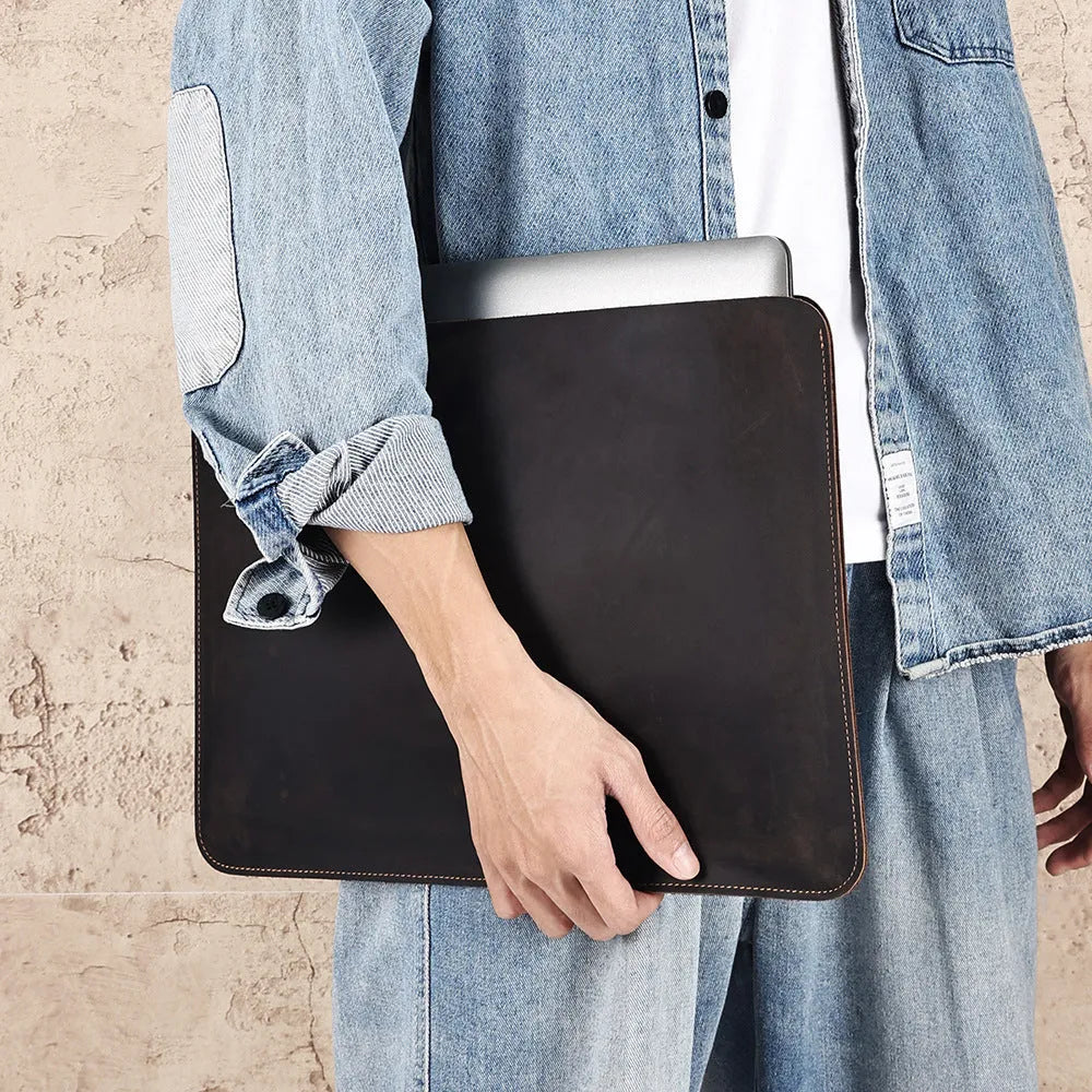 Brown horizontal computer liner bag made from cowhide leather showing laptop storage compartment
