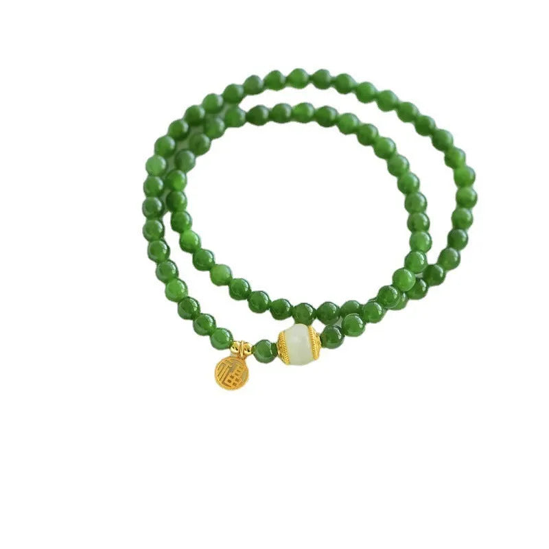 Women's double circle bracelet made of natural Hetian jade featuring a fu character symbol.