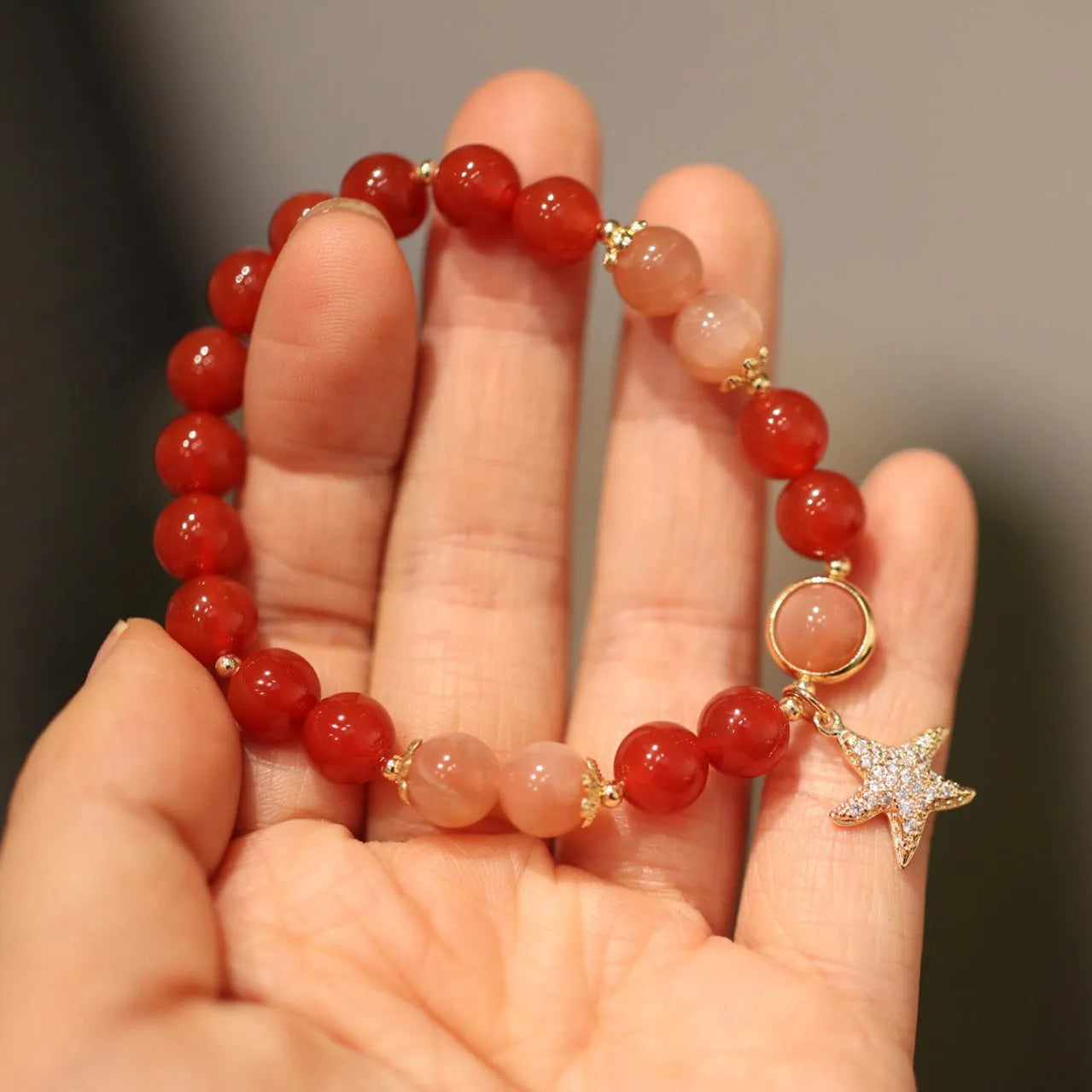 Handmade women's red agate bracelet with 8mm stones and ethnic star design featuring Xiangyun elements