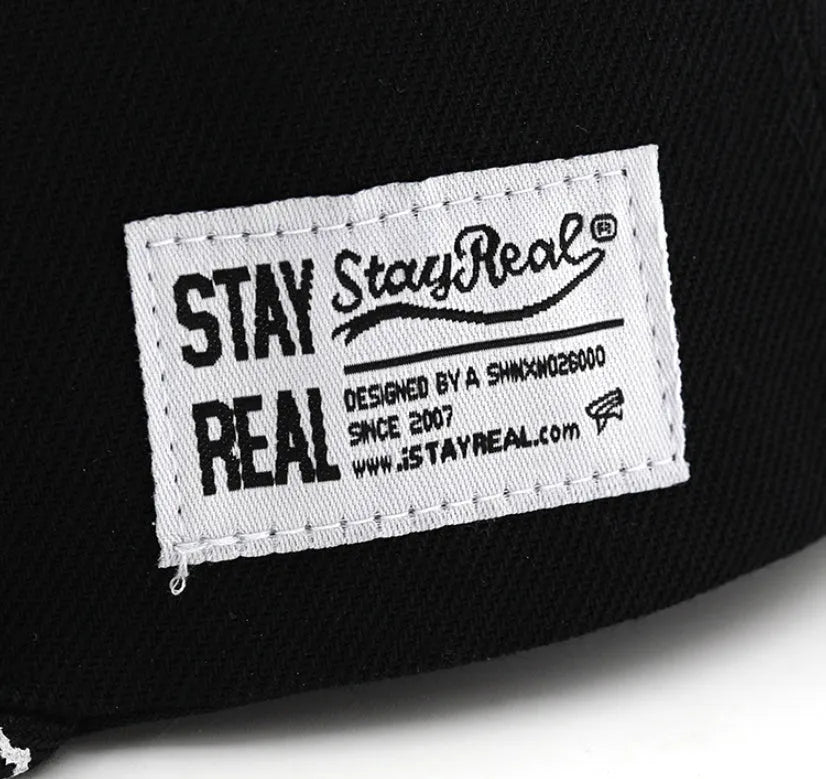 Cotton baseball hat with embroidered lettering in black colour showing adjustable strap