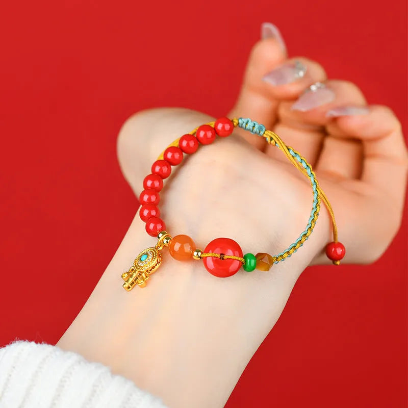 Cinnabar peace buckle woven bracelet in emperor red sand colour with hand-woven geometry design