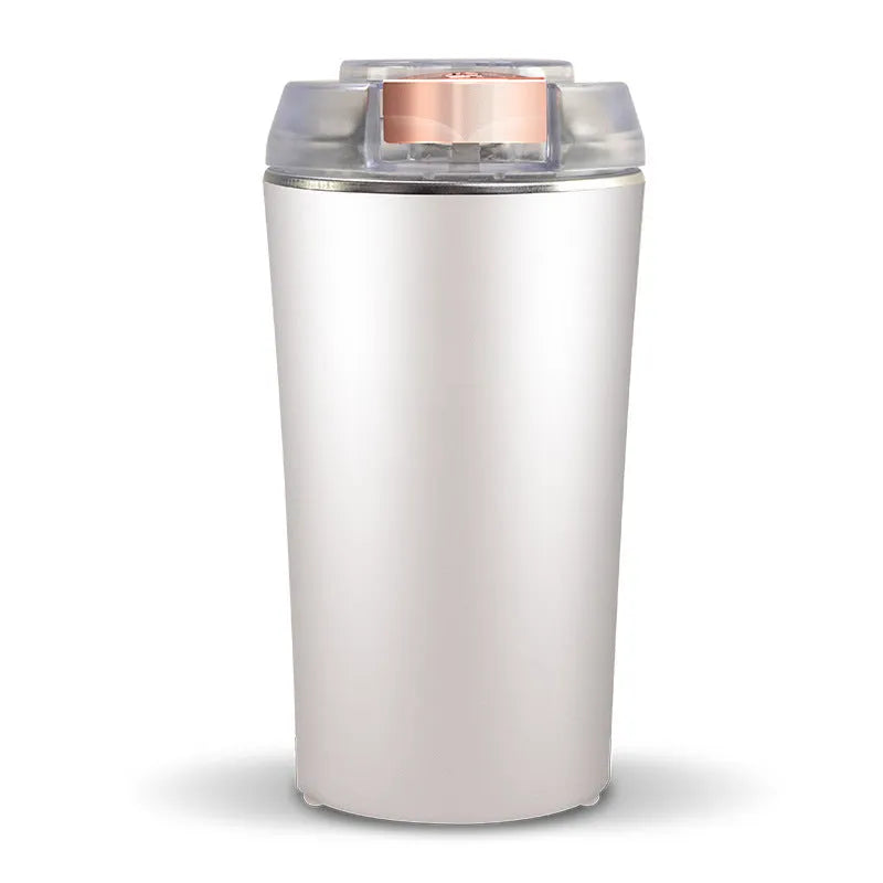 Blue mini food grinder and flour mill with stainless steel construction on a kitchen countertop.