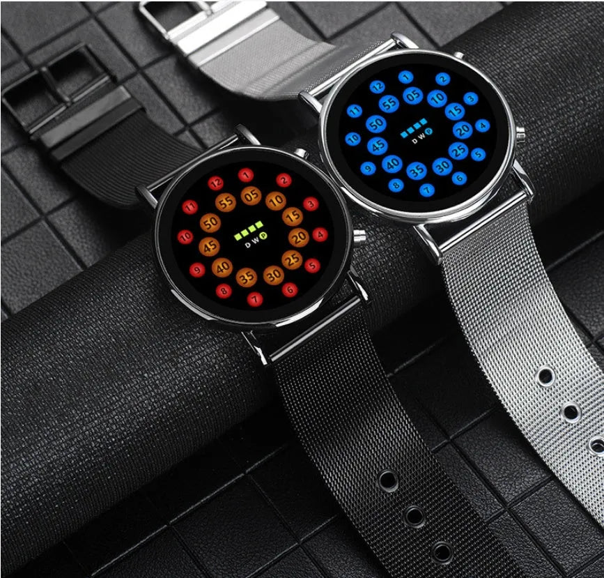 Black shell LED watch with blue illumination on stainless steel mesh strap showing 38mm round dial