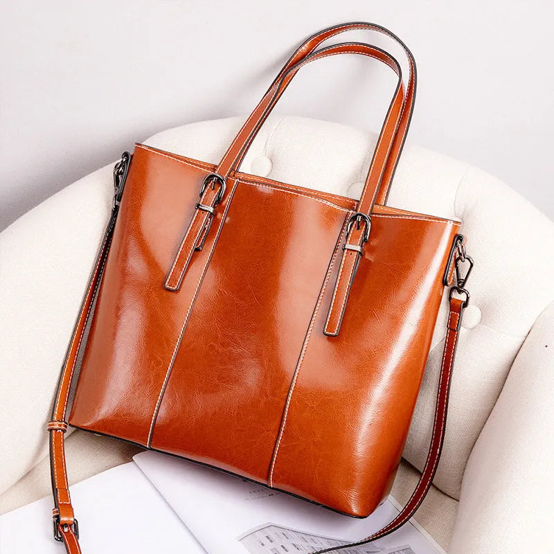 Brown genuine leather retro women's shoulder bag with three straps showing interior organisation compartments