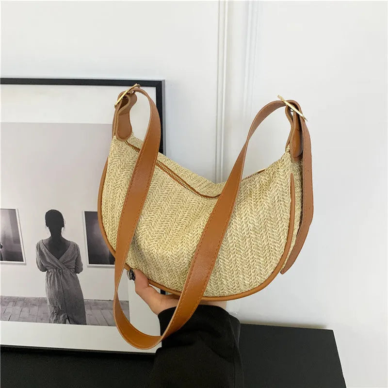 Women's woven straw crossbody bag showing internal phone pocket and document compartment