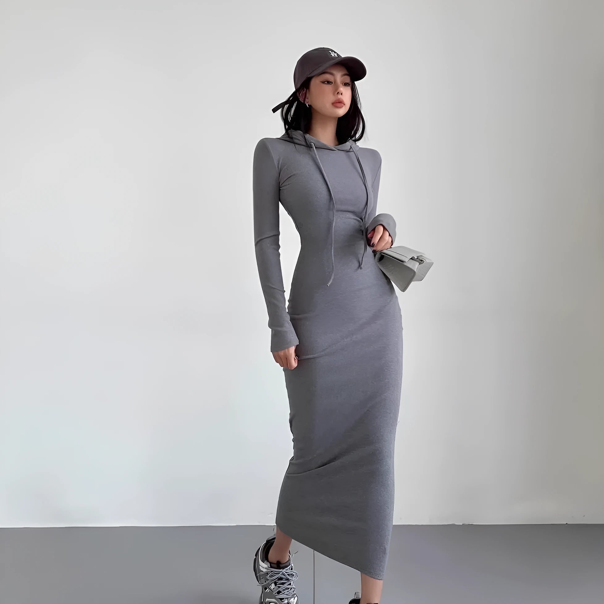 Women's grey hooded sheath dress with long sleeves and a high waist, shown in a front view.