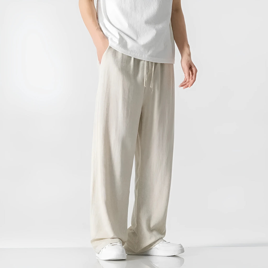 Men's beige bamboo fibre linen trousers with a straight leg, cropped length, and drawstring waist.